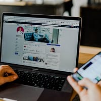 digital marketing person using both laptop and smartphone