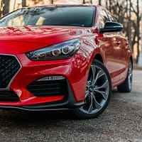 car transporters cost red car under tree