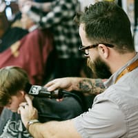 salon marketing ideas man shaving the boy's hair