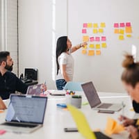 affiliate sales woman placing sticky notes on wall