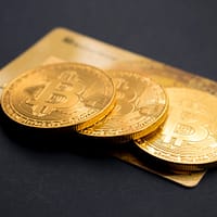 bitcoin three round gold-colored Bitcoin tokens