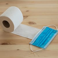 white toilet paper roll on brown wooden table