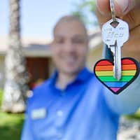 real estate agent selective photo of gray key with heart key chain