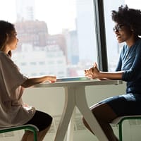 Job Interview two women sitting beside table and talking