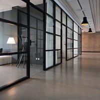 business office space hallway between glass-panel doors