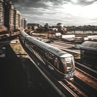 long train commute train running on railroad during daytime timelapse photography