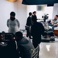 Production Studio people standing in front of computer monitor