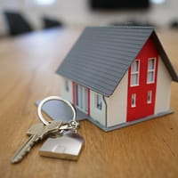 Search for Property white and red wooden house miniature on brown table