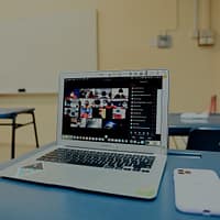 E-learning Videos macbook pro on blue table