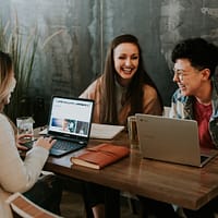 careers in education three people sitting in front of table laughing together