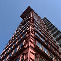 steel building low angle photography of pink high-rise building