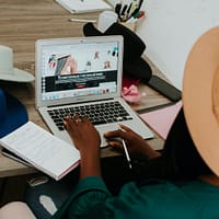 Home-Based Business person using macbook air on brown wooden table