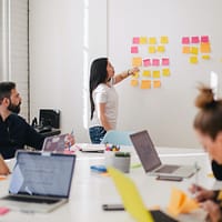 Leadership Development Program woman placing sticky notes on wall