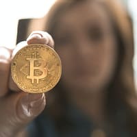 woman holding Bitcoin