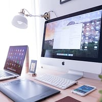 Web Applications silver iMac near iPhone on brown wooden table