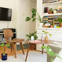 renting an apartment - brown wooden table and chair beside bookshelf