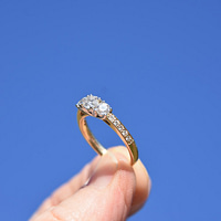 engagement ring person holding gold-colored ring