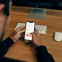 Surveying Customers man holding phone while leaning on table