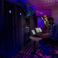 data room woman in blue long sleeve shirt sitting on black chair