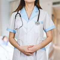 woman in white button up shirt and blue stethoscope