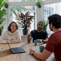 woman in white hijab sitting beside man in red crew neck t-shirt