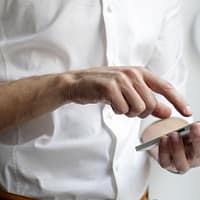 person holding white Android smartphone in white shirt