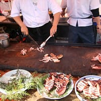 man slicing squids