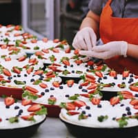 person decorating dishes on table