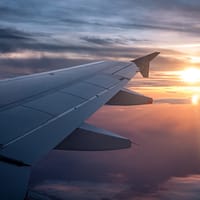 white airplane wing during sunset