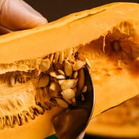 person holding sliced of yellow cheese