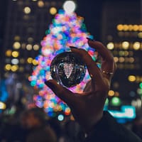 person holding clear glass ball