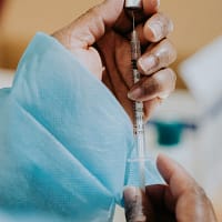 person holding clear glass tube