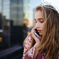 shallow focus photography of woman using smartphone outdoors