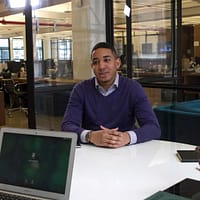 a man sitting at a table with a laptop