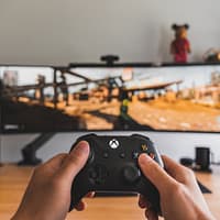 person holding black game controller