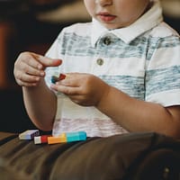 boy holding block toy