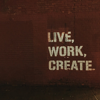 red brick wall with live, work, create. quote