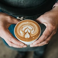 focus photography of coffee artwork