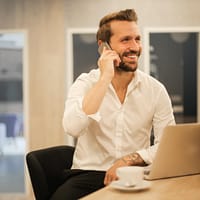 man using smartphone on chair