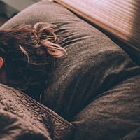 woman sleeping on bed