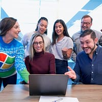 woman in maroon sweater using laptop