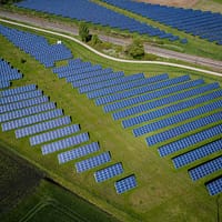 aerial photography of grass field with blue solar panels