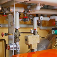 pipes and valves in a room with orange table