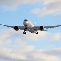 white passenger plane in mid air during daytime