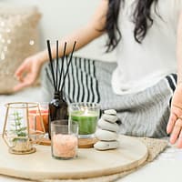 woman in white tank top holding black chopsticks