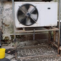 Air conditioner unit near wall of modern building on street