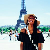 taxes woman standing behind eiffel tower