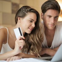 A couple looking at a laptop.