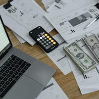 Banknotes and Calculator on Table