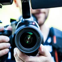 Person Holding Canon Dslr Camera Close-up Photo